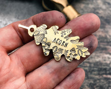 Load image into Gallery viewer, hand-stamped oak leaf dog tag with forest design
