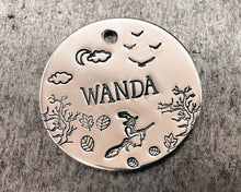 Load image into Gallery viewer, round dog id tag with spooky witch on a broom design