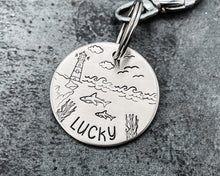 Load image into Gallery viewer, Ocean dog tag, hand stamped with sharks and lighthouse