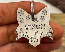 Load image into Gallery viewer, Christmas fox head dog id tag, hand stamped with cute reindeer, snowflakes and trees