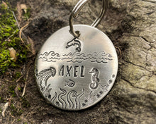 Load image into Gallery viewer, Ocean dog tag, hand stamped with seahorse, dolphin and waves