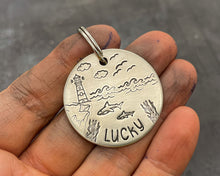 Load image into Gallery viewer, Ocean dog tag, hand stamped with sharks and lighthouse