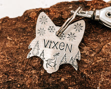 Load image into Gallery viewer, Christmas fox head dog id tag, hand stamped with cute reindeer, snowflakes and trees