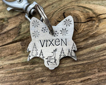 Load image into Gallery viewer, Christmas fox head dog id tag, hand stamped with cute reindeer, snowflakes and trees