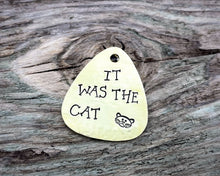 Load image into Gallery viewer, Guitar pick dog tag, hand stamped with 'it was the cat'