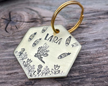 Load image into Gallery viewer, Hexagon dog tag, hand stamped with fairy design, flowers and feathers