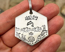 Load image into Gallery viewer, Hexagon dog tag, hand stamped with nautical design, dolphin & lighthouse