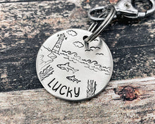 Load image into Gallery viewer, Ocean dog tag, hand stamped with sharks and lighthouse
