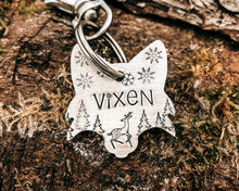 Load image into Gallery viewer, Christmas fox head dog id tag, hand stamped with cute reindeer, snowflakes and trees
