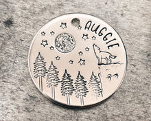 Load image into Gallery viewer, Large dog tag, hand stamped with howling wolf, trees, moon & stars