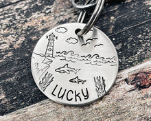 Load image into Gallery viewer, Ocean dog tag, hand stamped with sharks and lighthouse