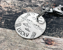 Load image into Gallery viewer, Ocean dog tag, hand stamped with sharks and lighthouse
