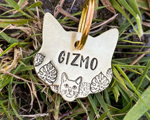 Load image into Gallery viewer, Cat head pet id tag, hand stamped with cute cat and leaves