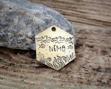Load image into Gallery viewer, Hexagon dog tag, hand stamped with nautical design, octopus & fish
