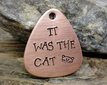 Load image into Gallery viewer, Guitar pick dog tag, hand stamped with 'it was the cat'