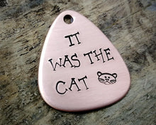 Load image into Gallery viewer, Guitar pick dog tag, hand stamped with 'it was the cat'