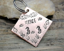 Load image into Gallery viewer, Square dog id tag, hand stamped with ocean design, seahorse & fish