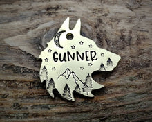 Load image into Gallery viewer, Wolf head dog tag, hand stamped with adventure design, mountains & trees