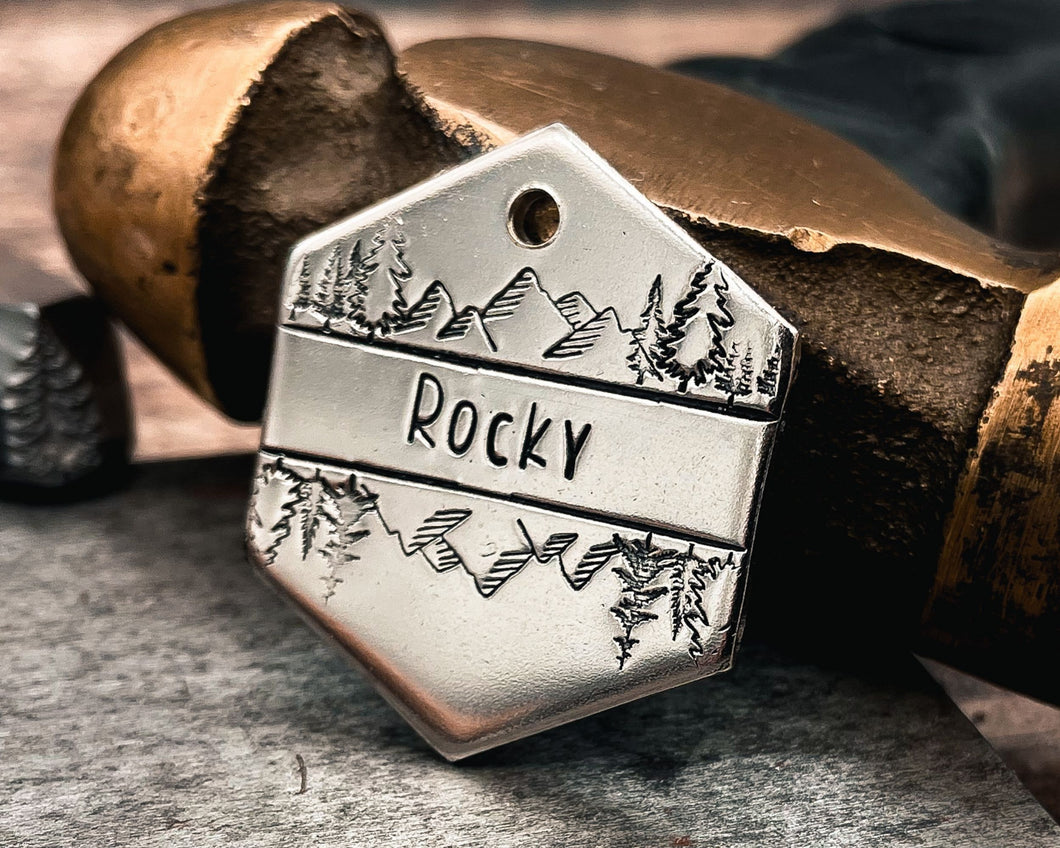 mountain dog id tag with trees hand-stamped