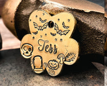 Load image into Gallery viewer, brass paw dog tag hand-stamped with spooky Halloween design
