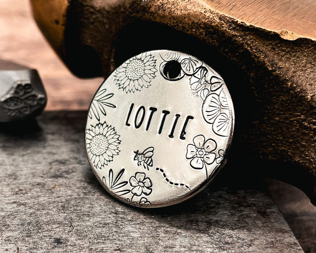 personalized dog tag with bee and flower design hand-stamped
