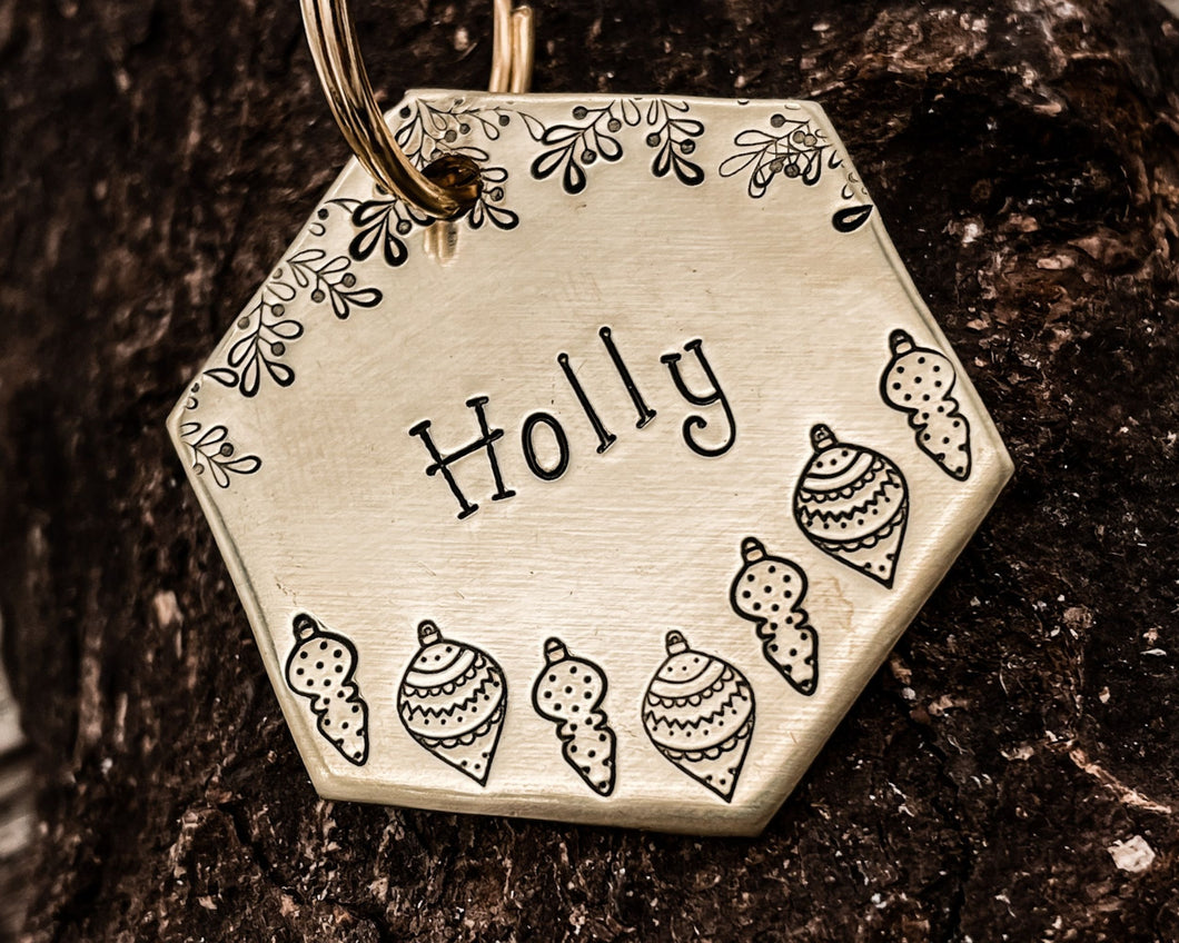 Christmas hexagon dog tag, hand stamped with holly and Christmas baubles