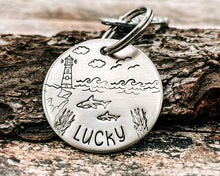 Load image into Gallery viewer, Ocean dog tag, hand stamped with sharks and lighthouse

