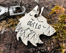 Load image into Gallery viewer, Wolf head dog tag, hand stamped metal dog tag with mountains &amp; trees

