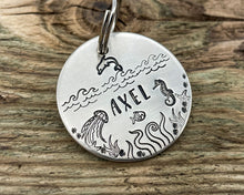 Load image into Gallery viewer, Ocean dog tag, hand stamped with seahorse, dolphin and waves
