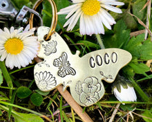 Load image into Gallery viewer, Daisy dog id tag, butterfly shaped pet tag, hand stamped with flowers
