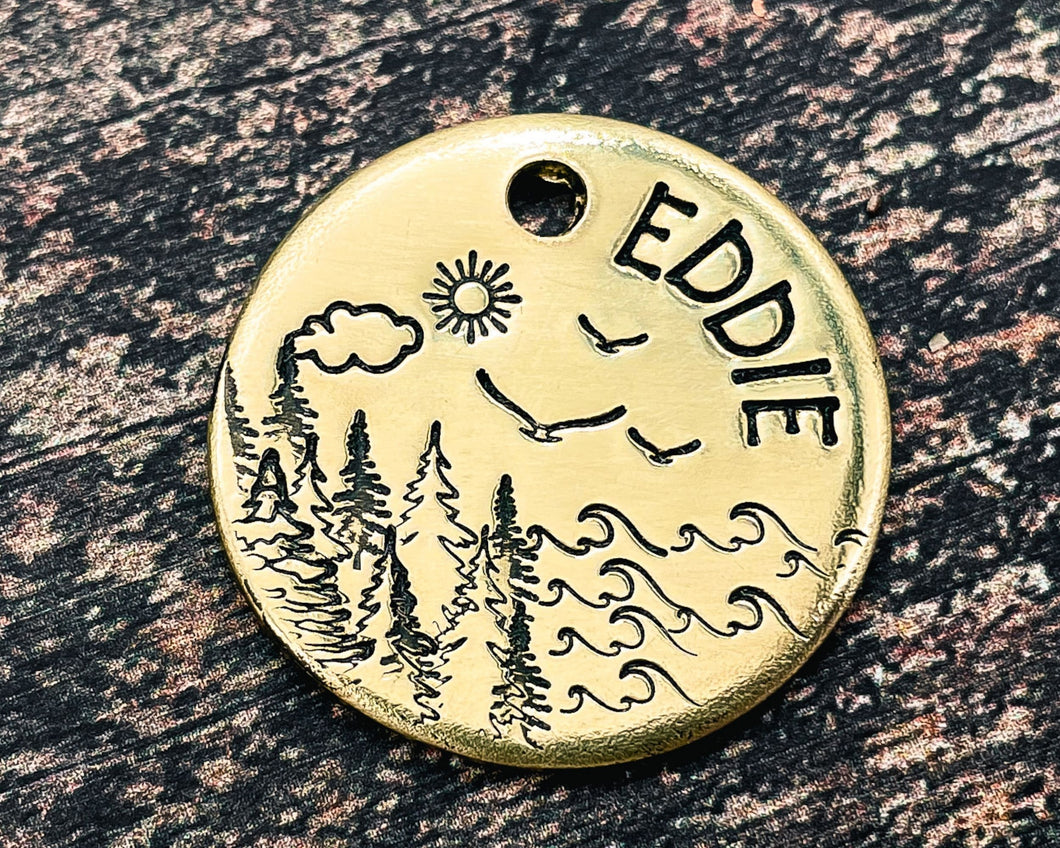 small metal dog id tag with lake and tree design