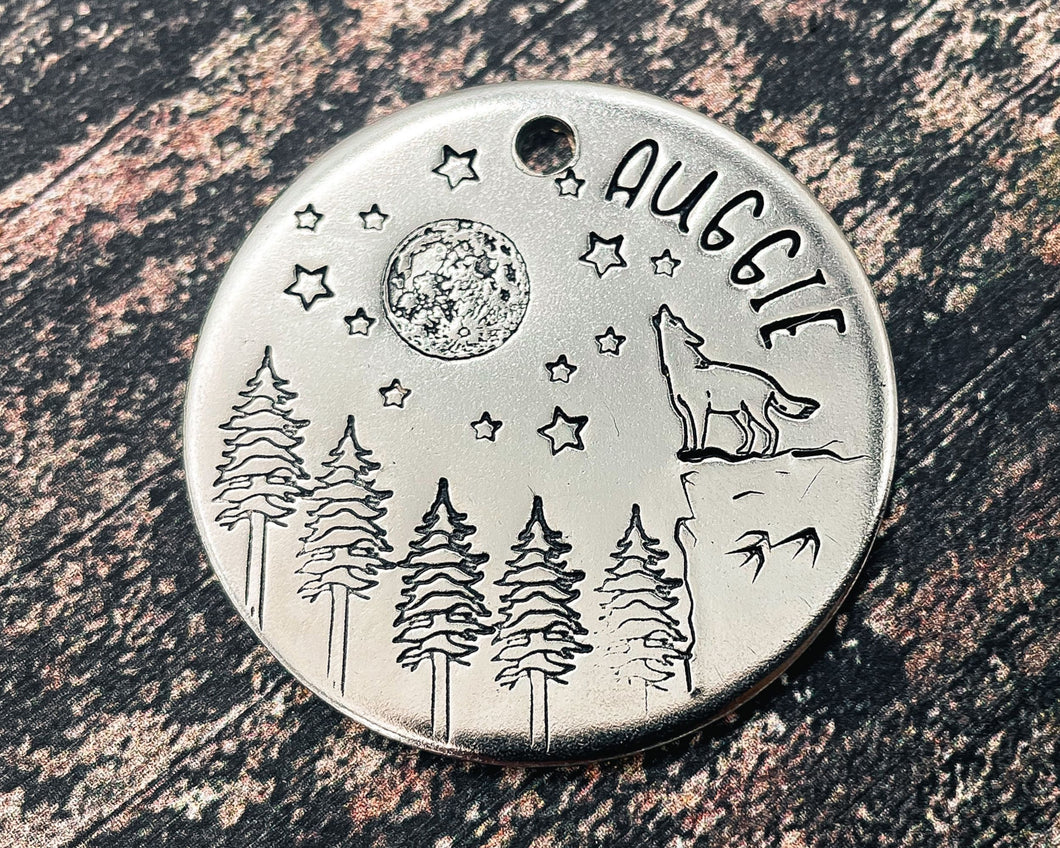 Large dog tag, hand stamped with howling wolf, trees, moon & stars