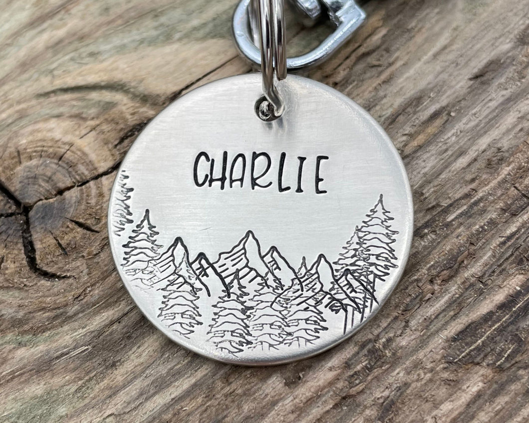 Dog name tag, hand stamped with mountains and trees