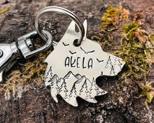 Load image into Gallery viewer, Wolf head dog tag, hand stamped metal dog tag with mountains &amp; trees
