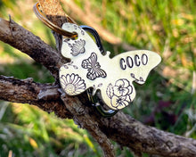 Load image into Gallery viewer, Daisy dog id tag, butterfly shaped pet tag, hand stamped with flowers
