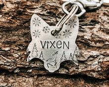 Load image into Gallery viewer, Christmas fox head dog id tag, hand stamped with cute reindeer, snowflakes and trees
