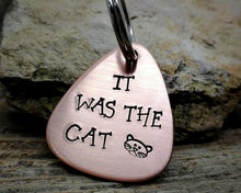Load image into Gallery viewer, Guitar pick dog tag, hand stamped with &#39;it was the cat&#39;

