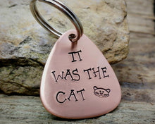 Load image into Gallery viewer, Guitar pick dog tag, hand stamped with &#39;it was the cat&#39;
