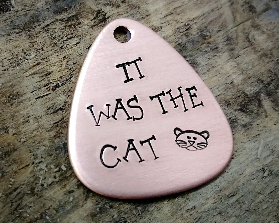 Guitar pick dog tag, hand stamped with 'it was the cat'