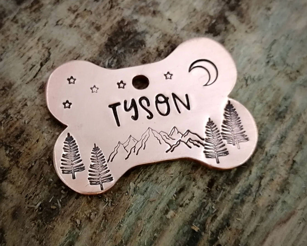 Bone dog tag, hand stamped with mountains & trees