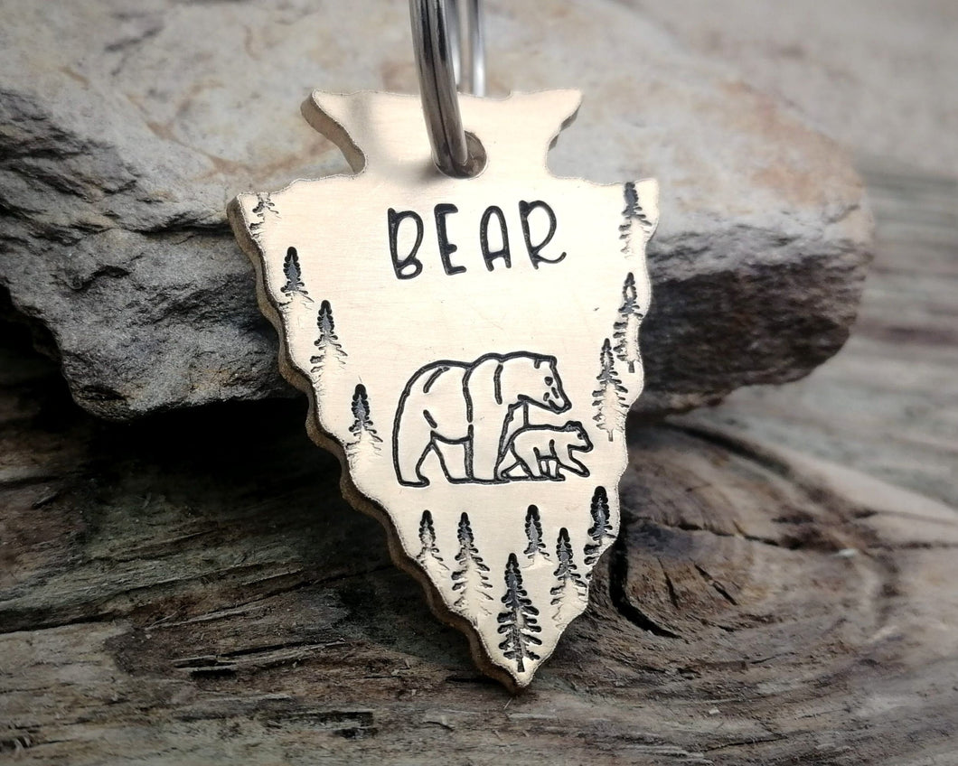 Arrow head dog tag with bear and trees